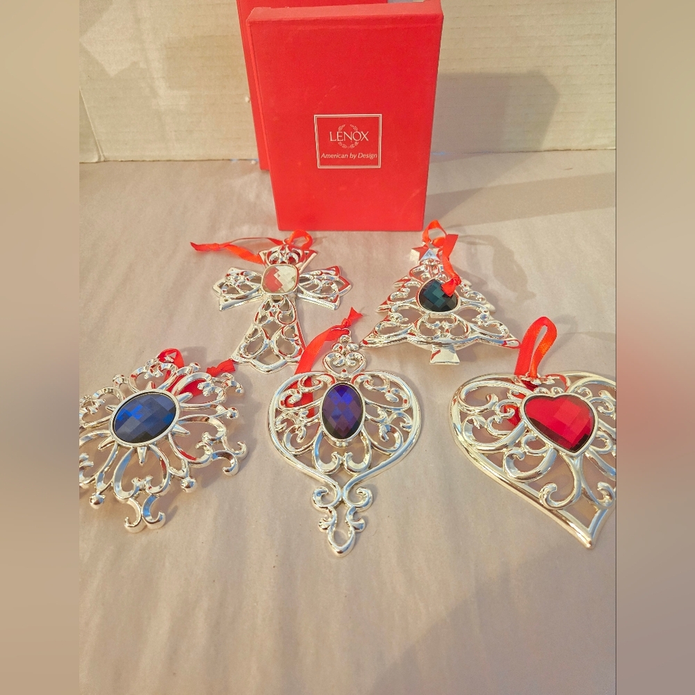 This is a Lenox Bejeweled Silverplated 5-Piece Holiday Ornament Set.